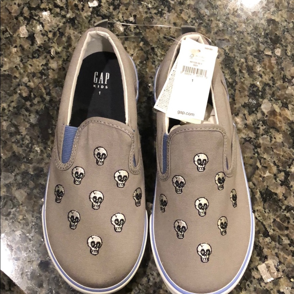 Young boys slip on skull shoes